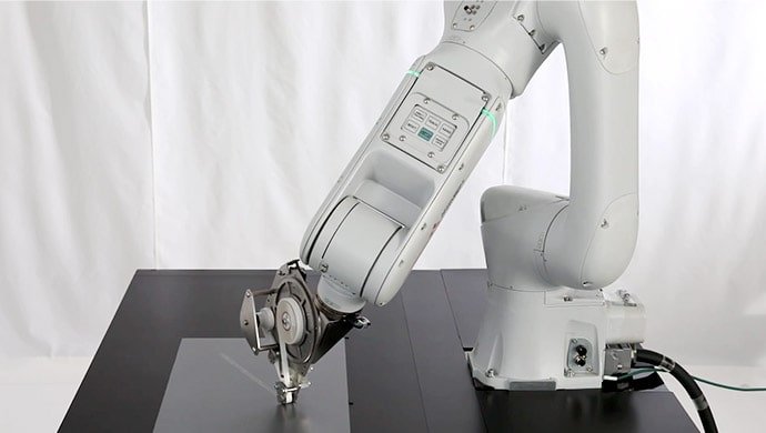 MELFA ASSISTA robot automates the application of double-sided tape in collaboration with workers